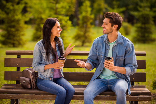 Portrait of his he her she nice attractive lovely charming cheerful cheery friendly married spouses wearing denim spending free spare time fresh air in green wood forest outdoors Portrait of his he her she nice attractive lovely charming cheerful cheery friendly, married spouses wearing denim spending free spare time fresh air in green wood forest outdoors park bench stock pictures, royalty-free photos & images