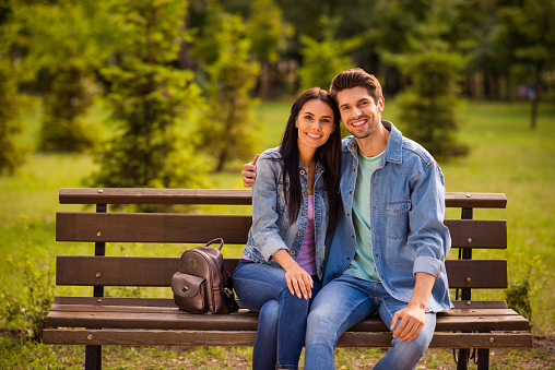 Portrait of his he her she nice attractive lovely charming amorous affectionate, cheerful cheery married spouses wearing denim embracing in green wood forest outdoors