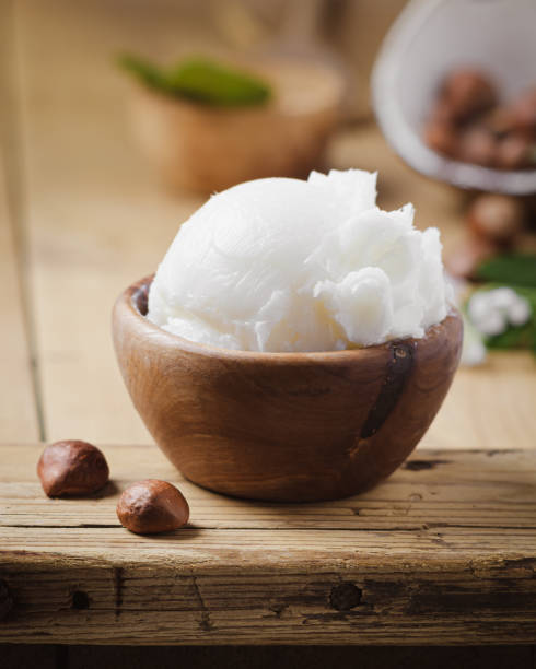 istock Shea butter in wooden bowl with nuts on old rustic table. Free text space. 1175721196