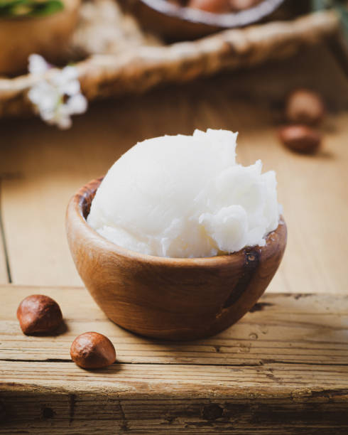 istock Shea butter in wooden bowl with nuts on old rustic table. Free text space. 1175721235