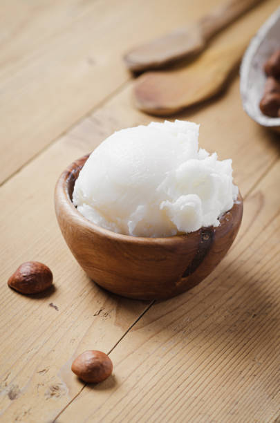 istock Shea butter in wooden bowl with nuts on old rustic table. Free text space. 1175721297