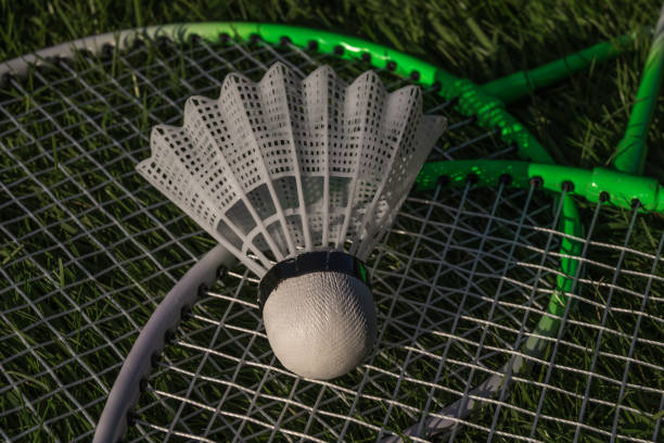 istock Shuttlecock and badminton rackets on green grass 1175723116