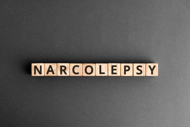 Narcolepsy - word from wooden blocks with letters Narcolepsy - word from wooden blocks with letters, sudden falling asleep narcolepsy concept,  top view on grey background narcolepsy stock pictures, royalty-free photos & images