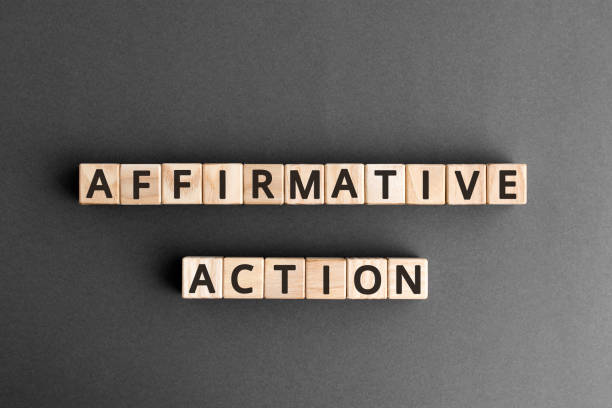 Affirmative Action - word from wooden blocks with letters Affirmative Action - word from wooden blocks with letters, gives preference to group of people affirmative action concept,  top view on grey background affirmative action photos stock pictures, royalty-free photos & images