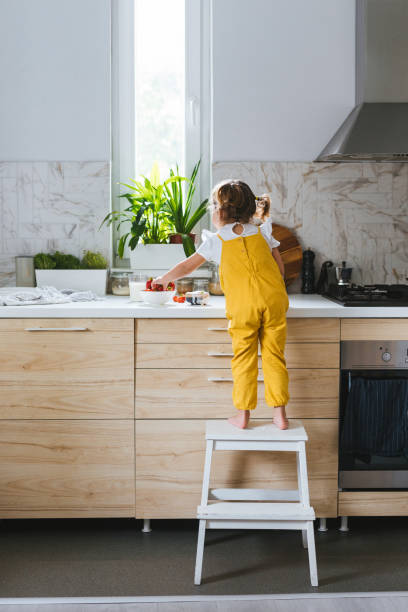 istock Little Girl Standing on Ladders 1175724118