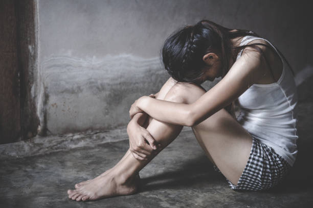 Young woman sitting on the floor with sadness and depression Young woman sitting on the floor with sadness and depression Trafficking stock pictures, royalty-free photos & images