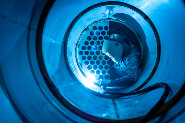 Welder man welding a multitubular heat exchanger