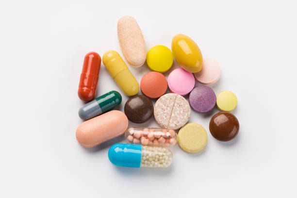 istock Assorted pharmaceutical medicine pills, tablets and capsules.Heap of assorted various medicine tablets and pills different colors on white background. 1175725886
