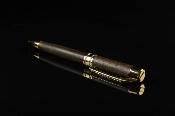 istock Beautiful handmade pen on a black mirror background 1175725956