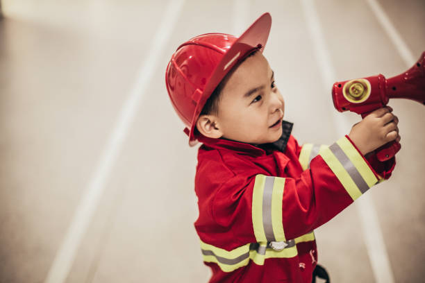 istock Toddler posing wearing a firefighter costume 1175728559