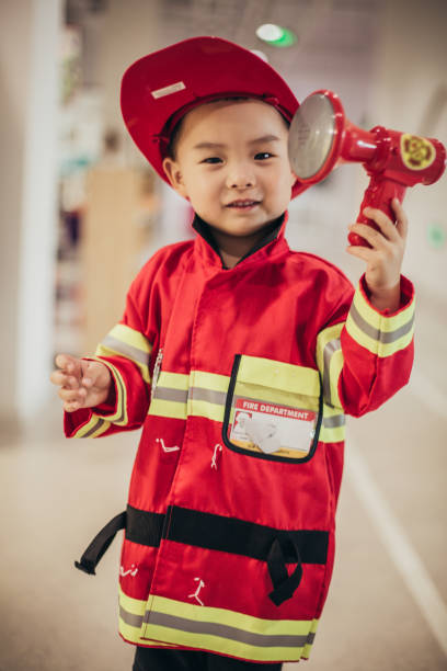 istock Toddler posing wearing a firefighter costume 1175729072