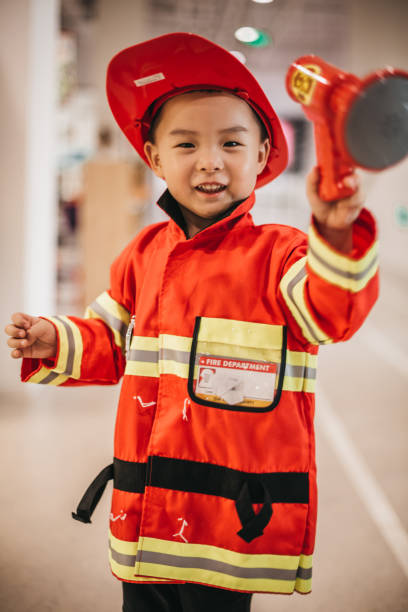 istock Toddler posing wearing a firefighter costume 1175729099