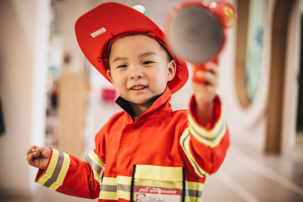 istock Toddler posing wearing a firefighter costume 1175729100