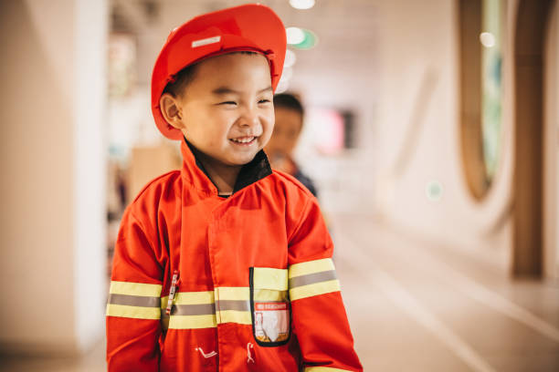 istock Toddler posing wearing a firefighter costume 1175729107