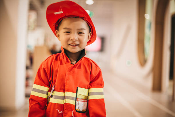 istock Toddler posing wearing a firefighter costume 1175729109