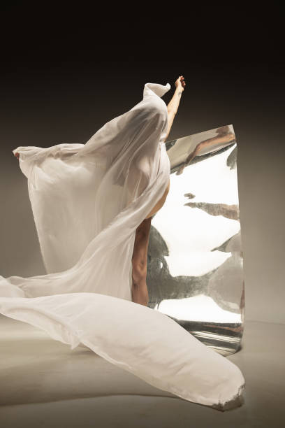 istock Young and stylish modern ballet dancer on brown background 1175729153