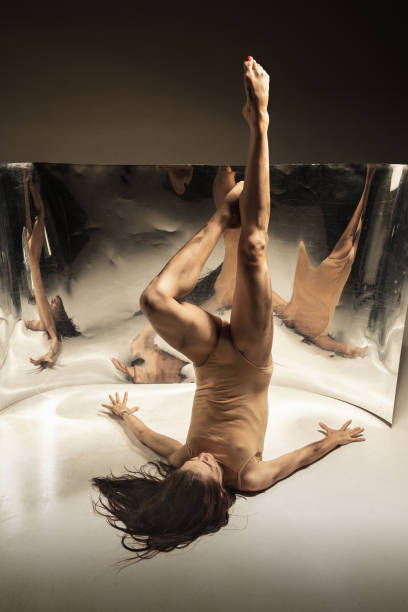 istock Young and stylish modern ballet dancer on brown background 1175729334
