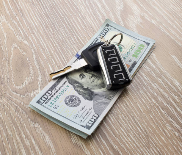 istock Car keys and dollars. Buying, selling a car 1175731650