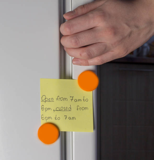 istock Hand opening refrigerator door and yellow sticker 1175732628