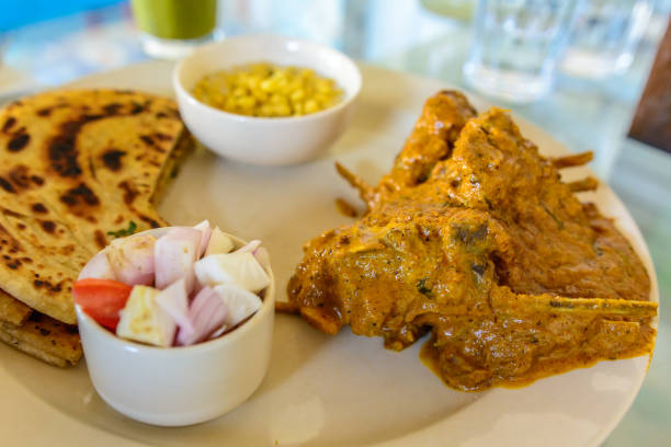 Mutton in spicy gravy served with parantha (Indian Bread) & Boondi Raita