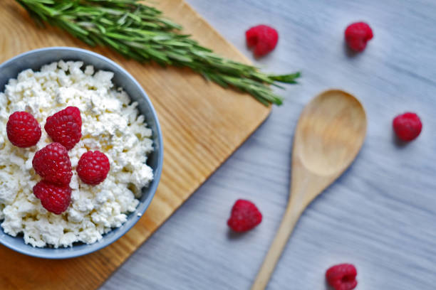 istock Cottage cheese with fresh raspberries in a bowl, healthy breakfast 1175733901