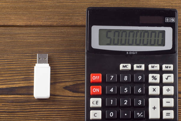 istock White USB flash drive and a clipboard on a wooden background 1175736122