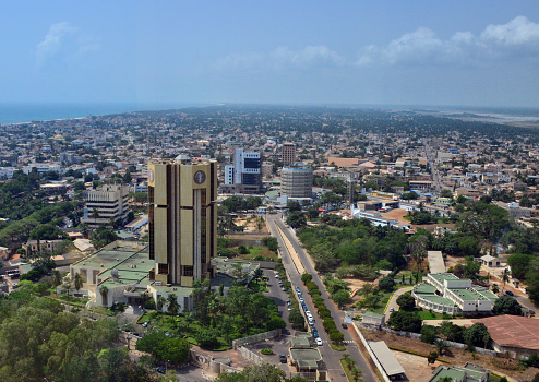 Lomé, Togo: view of the financial district, looking west along Abdoulaye Fadiga Avenue - left to right: the Benin Electrical Community (CEB), Central Bank of West African States tower (BCEAO), BSIC bank, Union Togolaise de Banques (UTB),  Fire Department, Ministry of Postal Services, Digital Economy and Technological Innovations, Societé Des Postes Du Togo, Deloitte... - Atlantic Ocean coast on the top left