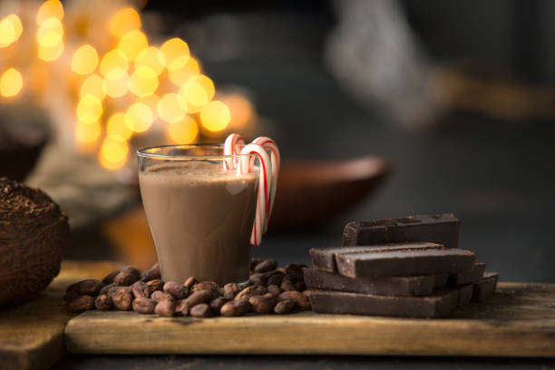 Italy: Thick Dark Hot Chocolate with Heart-Shaped Cookies on the Saucer. Some copy space on the lime-green background.