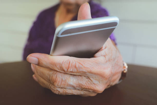 istock elder woman hand holding a mobile phone 1175741042