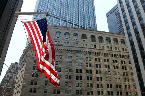 New York City at night with American flags and Chrysler building in the background