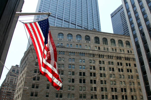 US Flag flying on the background of the facade of the Federal Reserve building in New York stock photo
