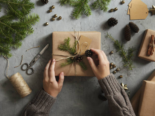 Woman decorating Christmas presents stock photo