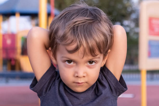 istock Little child boy looking at the camera posing at a playground 1175745997