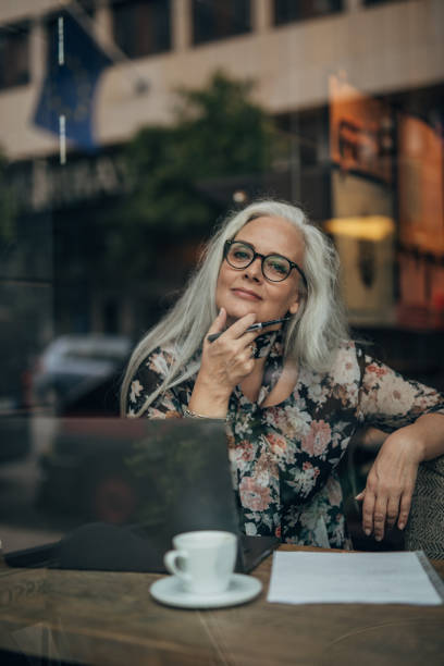 istock Pretty senior woman working on laptop 1175750716