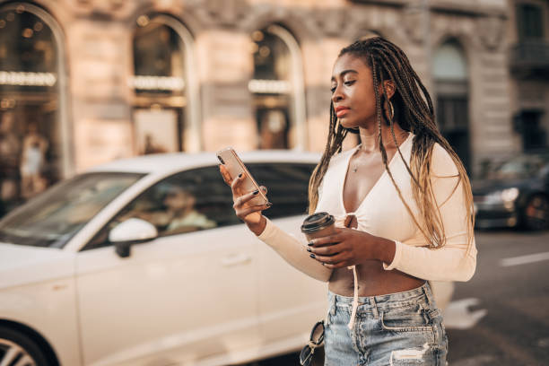 istock Young woman using a phone on the street 1175751047