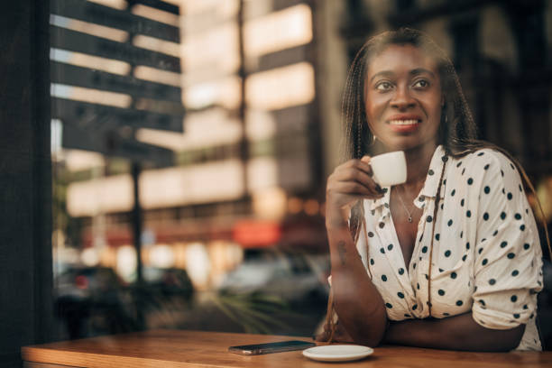 istock Young woman drinking coffee at the cafe 1175751475