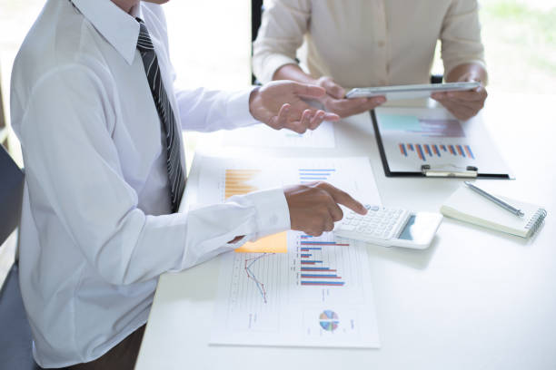 istock Midsection Of Businessmen Working At Desk In Office 1175754539