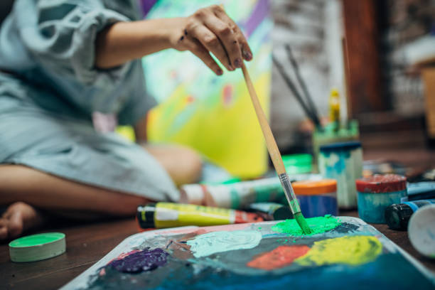 istock Creative woman painting in her studio 1175756143