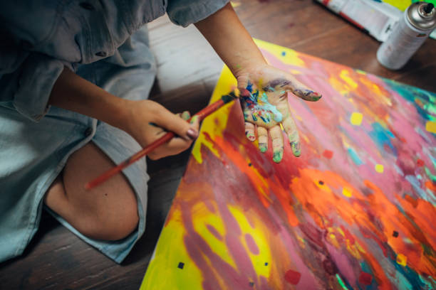 istock Creative woman painting in her studio 1175756235