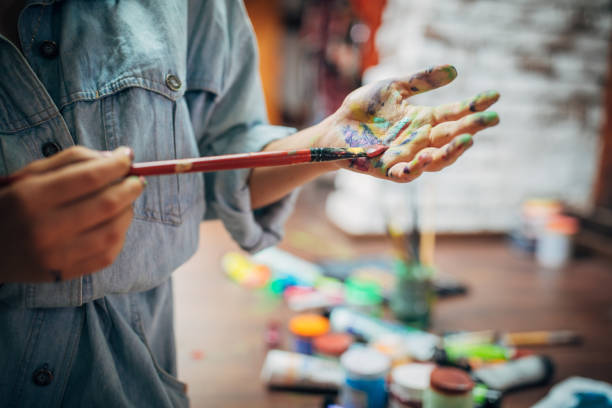 istock Creative woman painting in her studio 1175756327