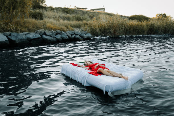 istock Young Woman Sleeping On Bed In Lake 1175756530