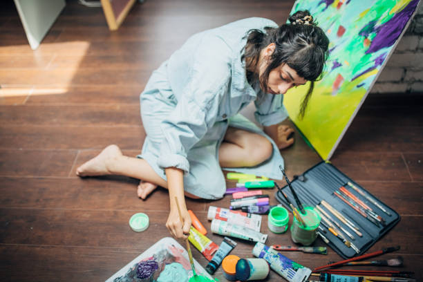 istock Woman painting in her art studio 1175757956