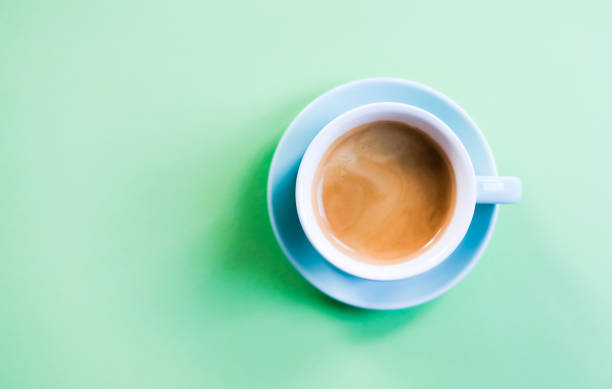 istock Cup of coffee on green background 1175760961