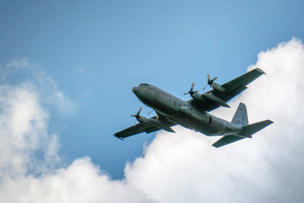 A Hercules airplane leaves after having dropped paratroopers during the 75th anniversary of the Market Garden Operation This photo was taken at the 75th anniversary of the dropping of para troops in Groesbeek. That happened on September 17, 1944 in the context of Operation Market Garden. In a few days, almost 8,000 American paratroopers were dropped in the immediate surroundings of Groesbeek. In the first days after September 17, the surroundings of Groesbeek and Nijmegen changed into a hellish front area. The bridges of Nijmegen were conquered intact, but had to be defended against all German attacks in the following days and weeks. The Rhine bridge near Arnhem eventually had to be abandoned by the English paratroopers. Large parts of the area south of Nijmegen were freed. This was of great strategic importance for the course of the war; from here the Rhineland offensive, the attack on the German flank, could be deployed. operation market garden stock pictures, royalty-free photos & images