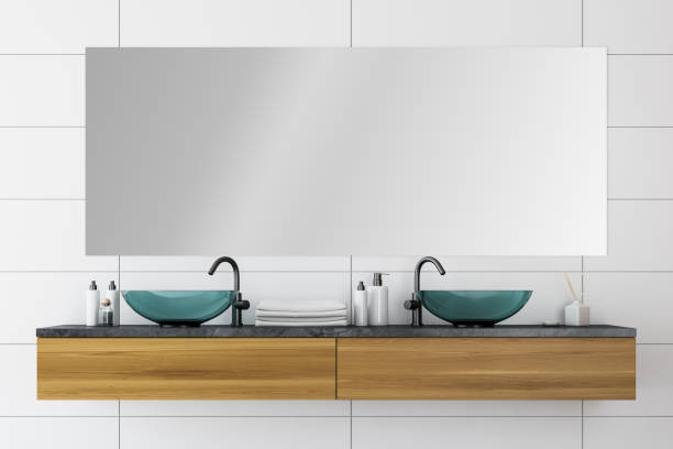 istock Close up of double sink in white tile bathroom 1175763836