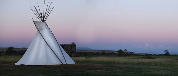 a white teepee glows at dusk - dusk blue montana landscape imagens e fotografias de stock