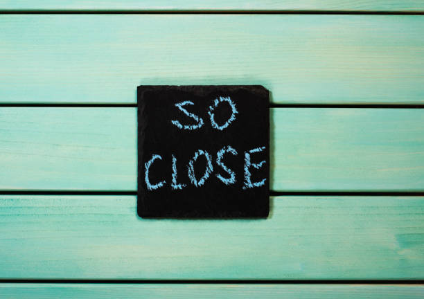 istock So close words written with chalk on blue wooden background 1175766946