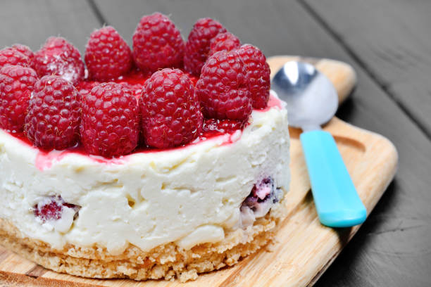 istock Mini cheesecake with white chocolate and raspberries on table 1175768060