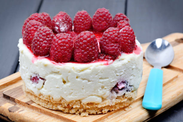 istock Mini cheesecake with white chocolate and raspberries on cutting board 1175768444