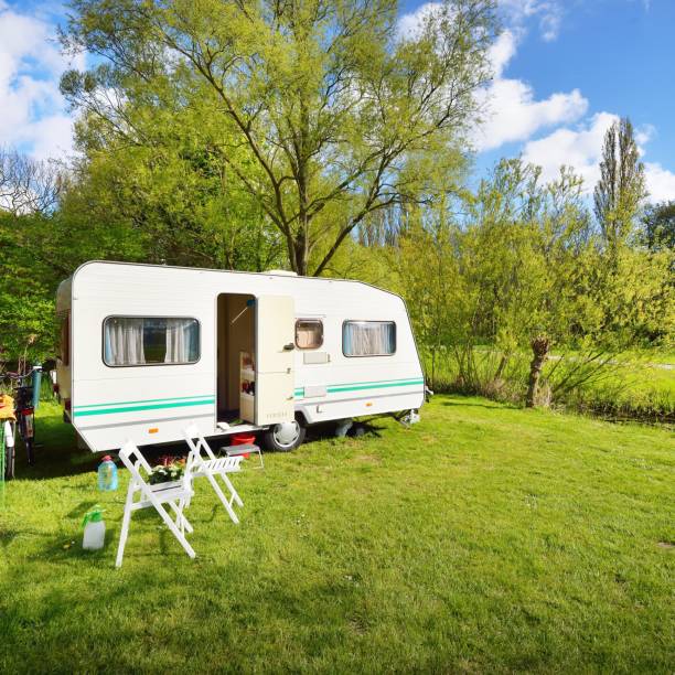 istock Caravan trailer on a green lawn, on a sunny spring day 1175769520